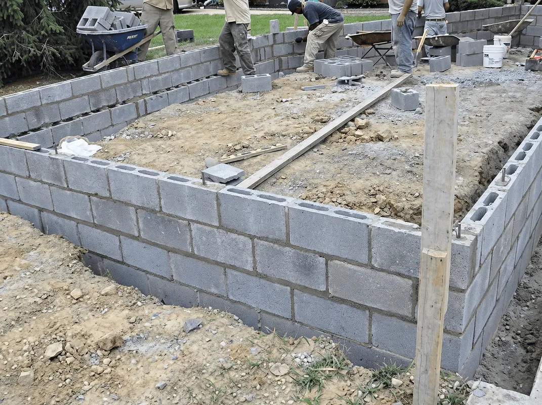 Professionals building a foundation with blocks in ,